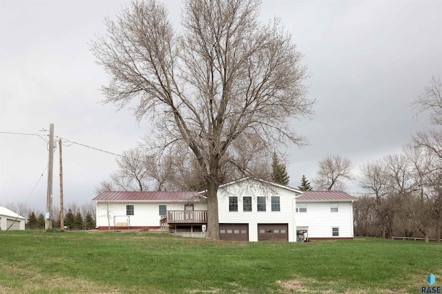 47743 233a St, Egan, SD 57024 - rear view of property with an attached garage, a wooden deck, metal roof, and a yard
