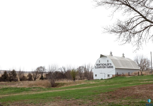 47743 233a St, Egan, SD 57024 - view of home's exterior with a gambrel roof, a barn, an outbuilding, and a lawn