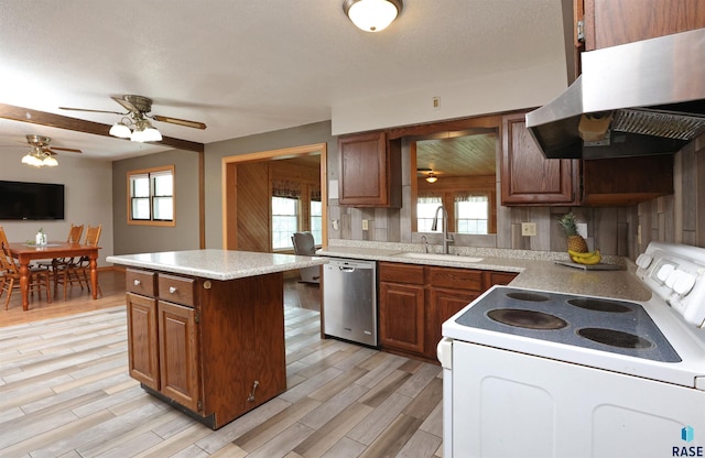 47743 233a St, Egan, SD 57024 - kitchen with white electric range, stainless steel dishwasher, a sink, under cabinet range hood, and light countertops