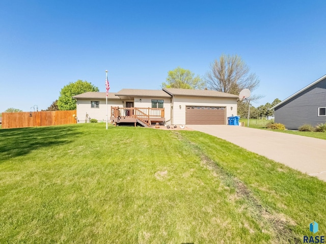 view of front of home featuring concrete driveway, an attached garage, and a deck