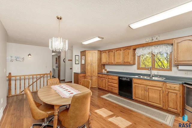 kitchen featuring dishwasher, a sink, light wood-type flooring, a chandelier, and dark countertops