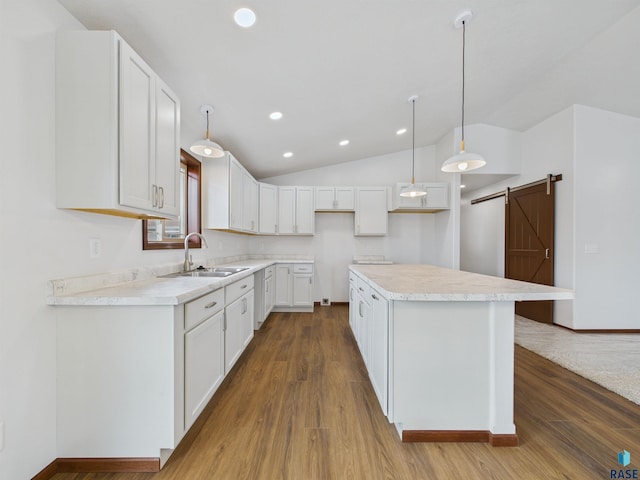 1180 Ruud Trl, Hartford, SD 57033 - kitchen featuring a barn door, a sink, dark wood-style floors, a center island, and lofted ceiling