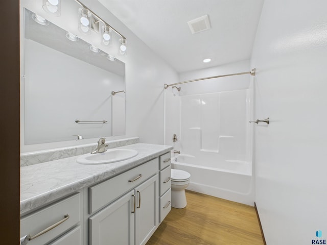 1180 Ruud Trl, Hartford, SD 57033 - bathroom with toilet, wood finished floors, vanity, and shower / bath combination