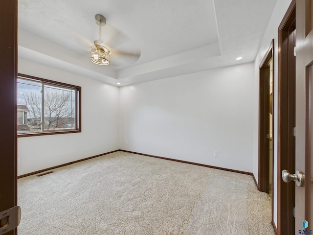 1180 Ruud Trl, Hartford, SD 57033 - empty room with carpet flooring, a ceiling fan, a raised ceiling, baseboards, and recessed lighting