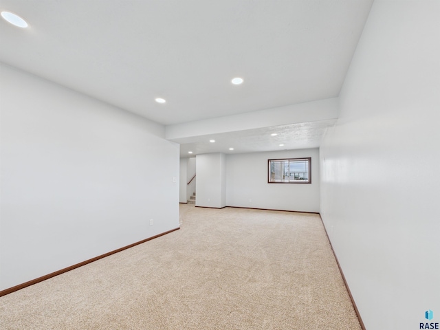 1180 Ruud Trl, Hartford, SD 57033 - below grade area with recessed lighting, light carpet, stairway, and baseboards