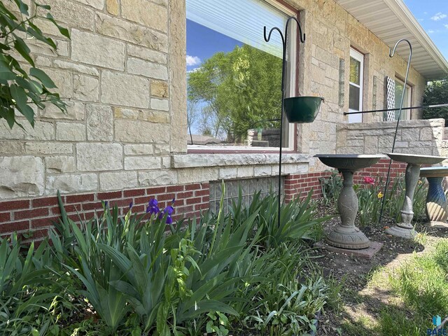 view of property exterior featuring stone siding and brick siding
