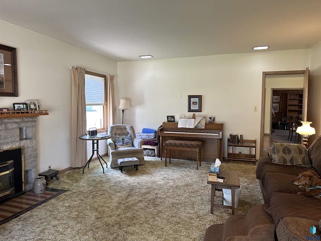living room featuring carpet and a stone fireplace