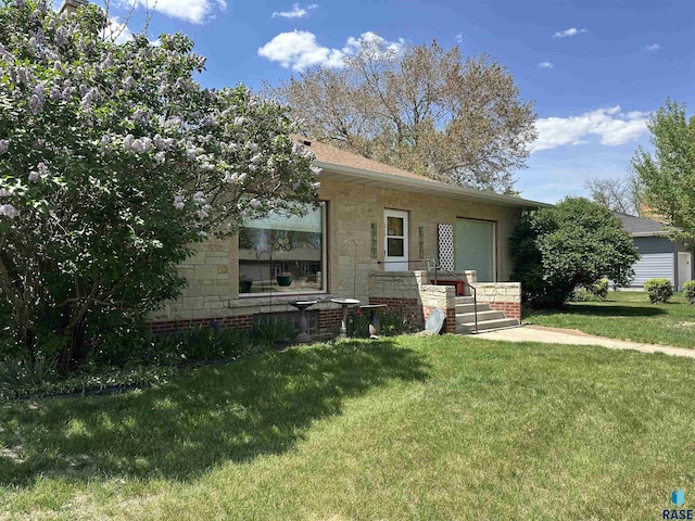 view of front of property with a front yard and stone siding