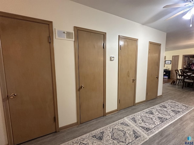 hallway with wood finished floors and baseboards