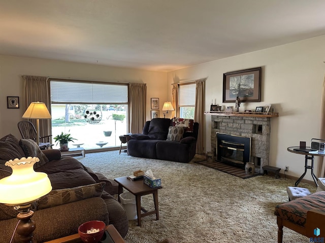 living area with carpet flooring and a glass covered fireplace