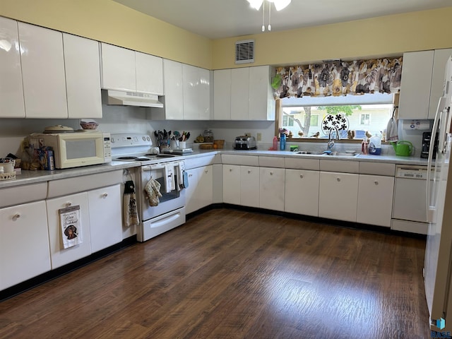 kitchen featuring white appliances, under cabinet range hood, a sink, and light countertops