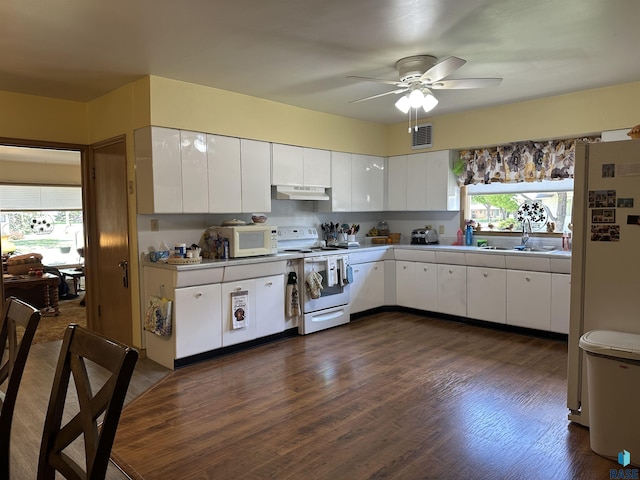 kitchen with white appliances, a sink, under cabinet range hood, white cabinets, and ceiling fan