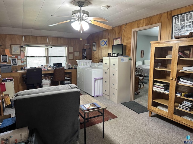 office area with independent washer and dryer, wooden walls, carpet flooring, and ceiling fan