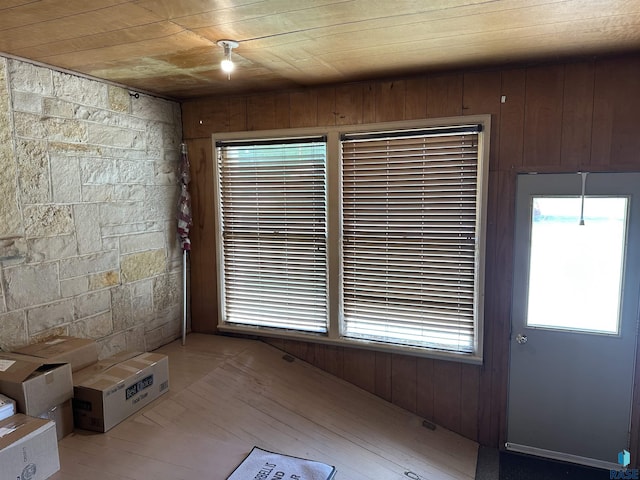 interior space featuring wooden ceiling, wooden walls, and hardwood / wood-style flooring