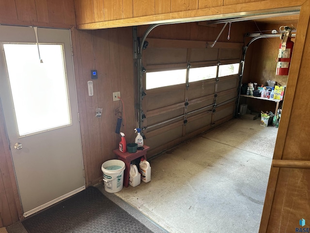 garage featuring wood walls