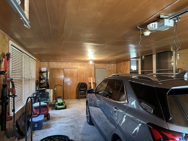garage featuring a garage door opener, wood walls, and wooden ceiling