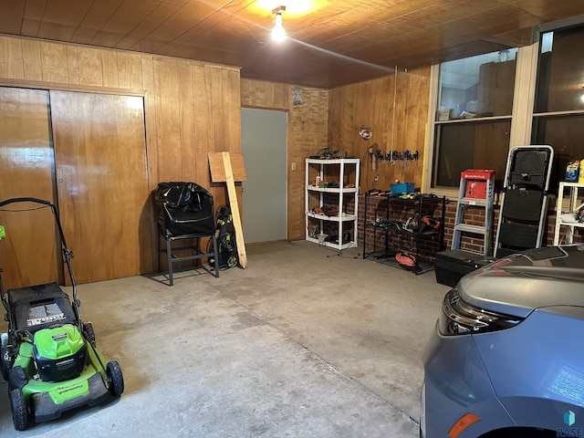 garage featuring wood walls and wood ceiling