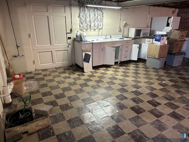 kitchen featuring stainless steel microwave, dark flooring, and white cabinets