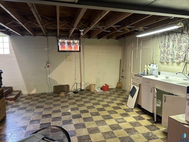 basement with a sink and tile patterned floors