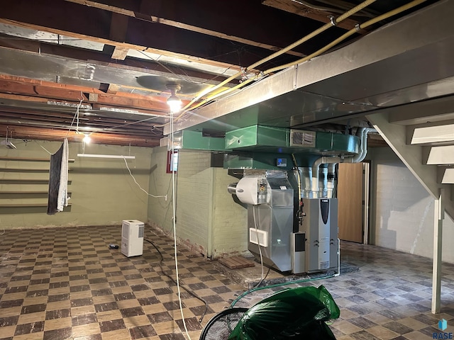unfinished basement with tile patterned floors, stairway, and heating unit