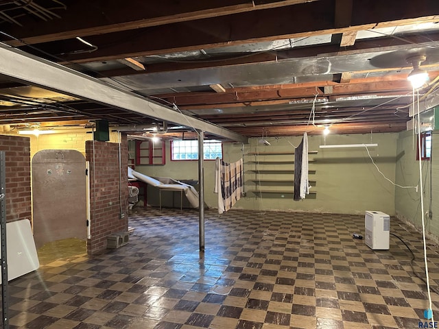 below grade area featuring tile patterned floors and stairs