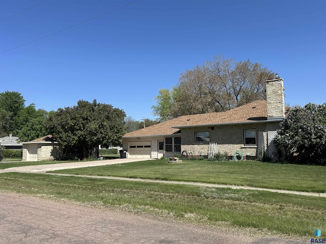 ranch-style home with an attached garage, driveway, a front lawn, a chimney, and stone siding