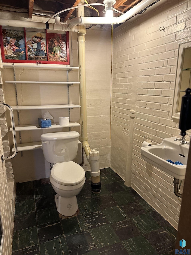 bathroom with a sink, toilet, and tile patterned floors