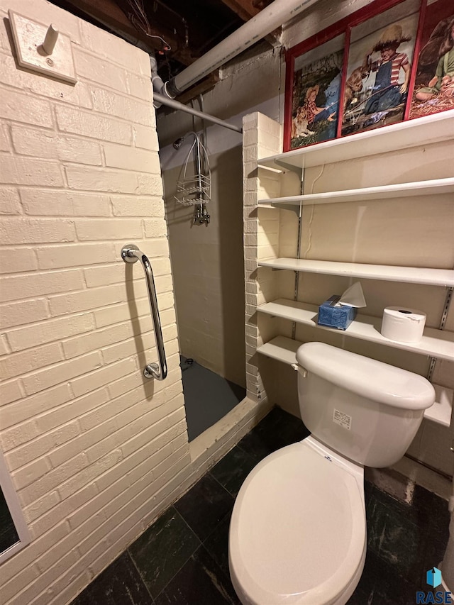 bathroom featuring a shower stall and toilet