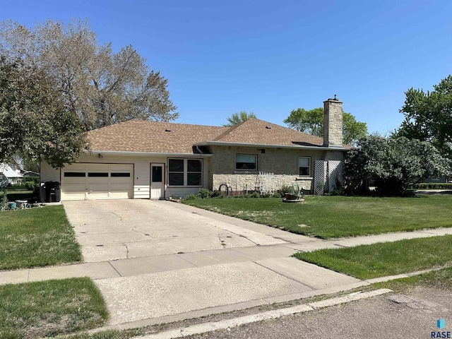 single story home featuring an attached garage, a front yard, driveway, and a chimney