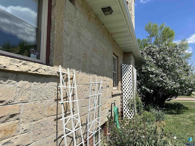 view of property exterior with stone siding