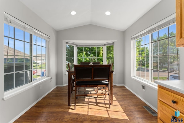 dining room with dark wood-type flooring, lofted ceiling, baseboards, and recessed lighting