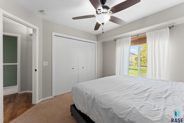 carpeted bedroom with a closet, a ceiling fan, and baseboards