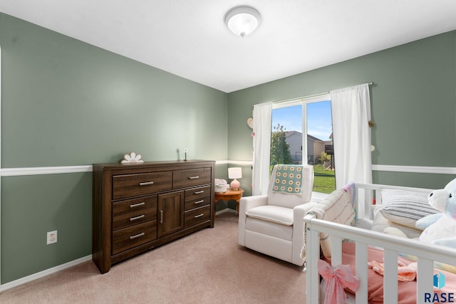 bedroom featuring light carpet and baseboards