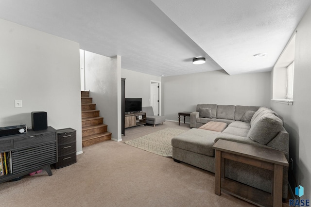 living room featuring light carpet, stairs, and baseboards