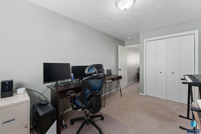 home office featuring light colored carpet and baseboards