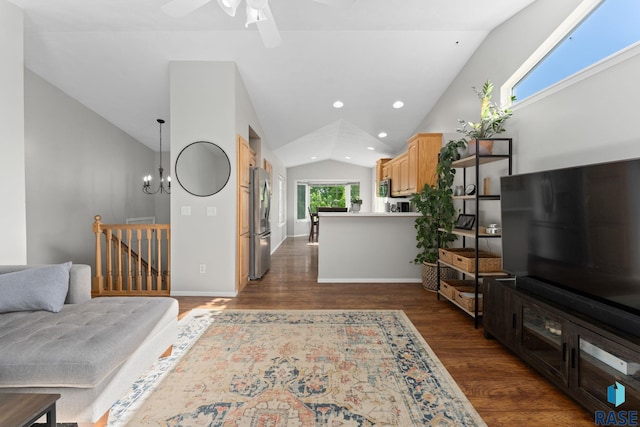 living area featuring lofted ceiling, dark wood finished floors, a ceiling fan, recessed lighting, and a chandelier