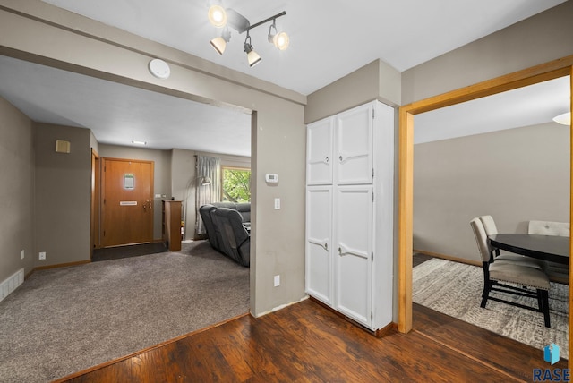 dining room featuring dark wood-type flooring and baseboards