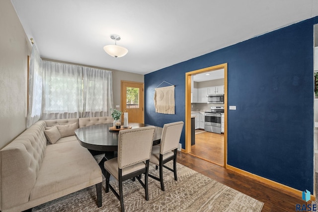 dining area featuring wood finished floors and baseboards