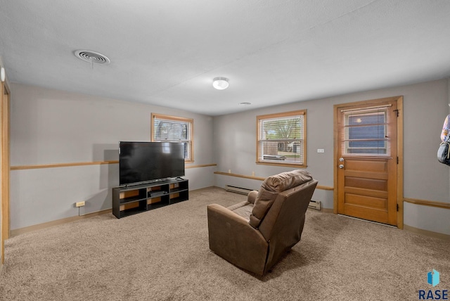 living area with a baseboard radiator, carpet, and baseboards