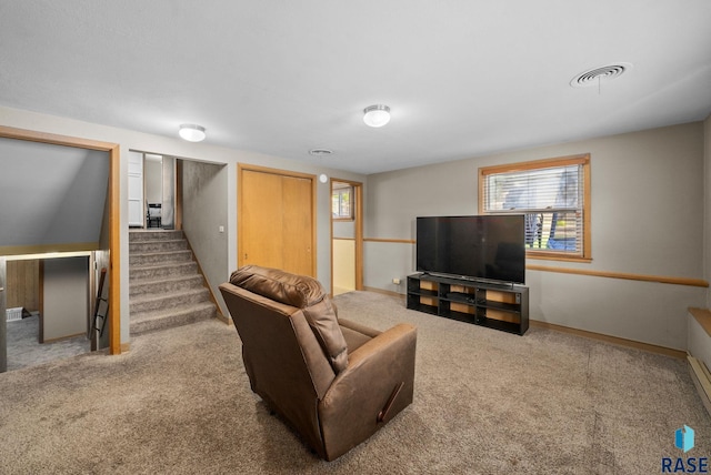 living area featuring carpet flooring, stairway, and baseboards