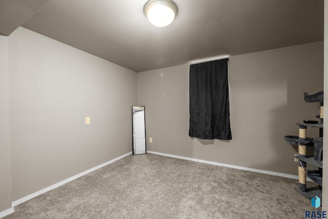 unfurnished room with carpet floors and baseboards