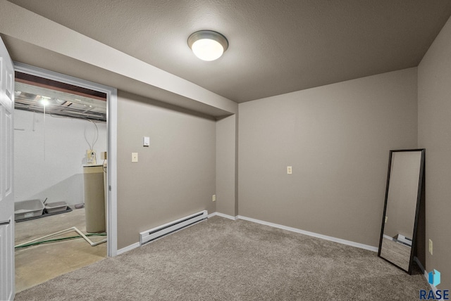 finished basement with a baseboard heating unit, carpet, and baseboards