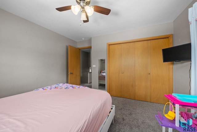 carpeted bedroom featuring a closet and ceiling fan