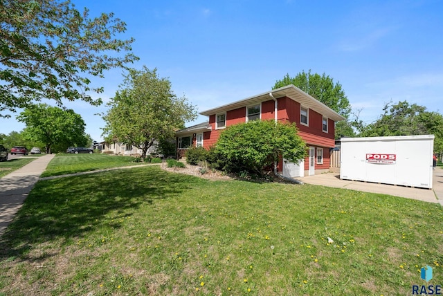 view of side of home with a yard
