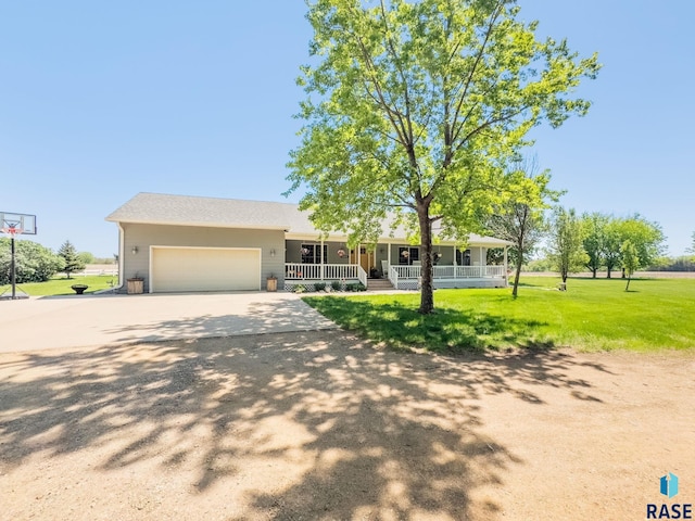ranch-style house featuring a porch, an attached garage, a front yard, and concrete driveway