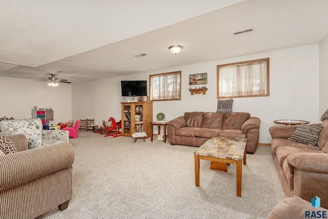 carpeted living room featuring ceiling fan