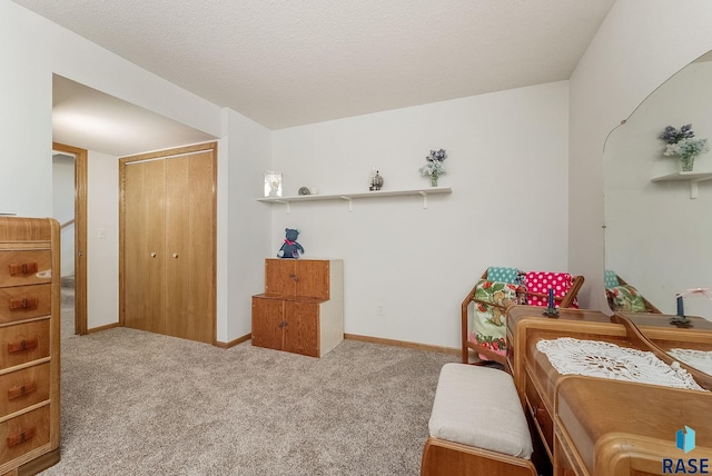 carpeted bedroom featuring a closet and baseboards
