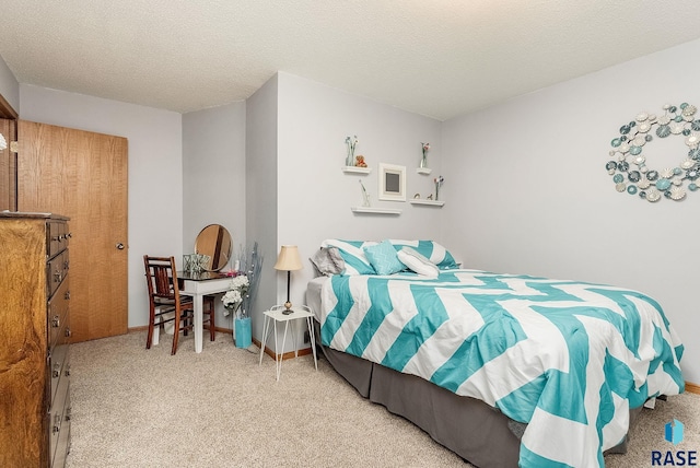 bedroom featuring carpet and a textured ceiling