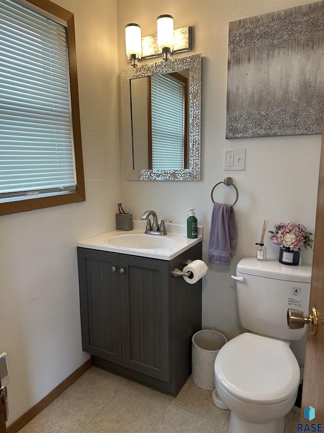 531 N Adams St, Salem, SD 57058 - bathroom with toilet, tile patterned flooring, vanity, and baseboards