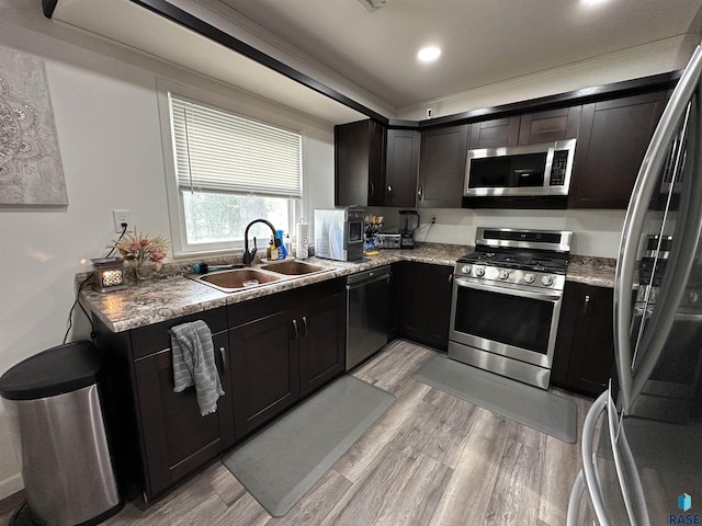 531 N Adams St, Salem, SD 57058 - kitchen with appliances with stainless steel finishes, a sink, light wood-type flooring, recessed lighting, and light stone counters